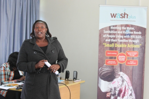 Caroline Vata, a government public health officer, presents a case study during the WASHplus Kenya end-of-project experience-sharing workshop  of in Nairobi September 25th 2014. Photo: George Obanyi