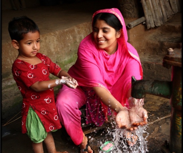 Mother and child in Bangladesh wash hands before mealtime